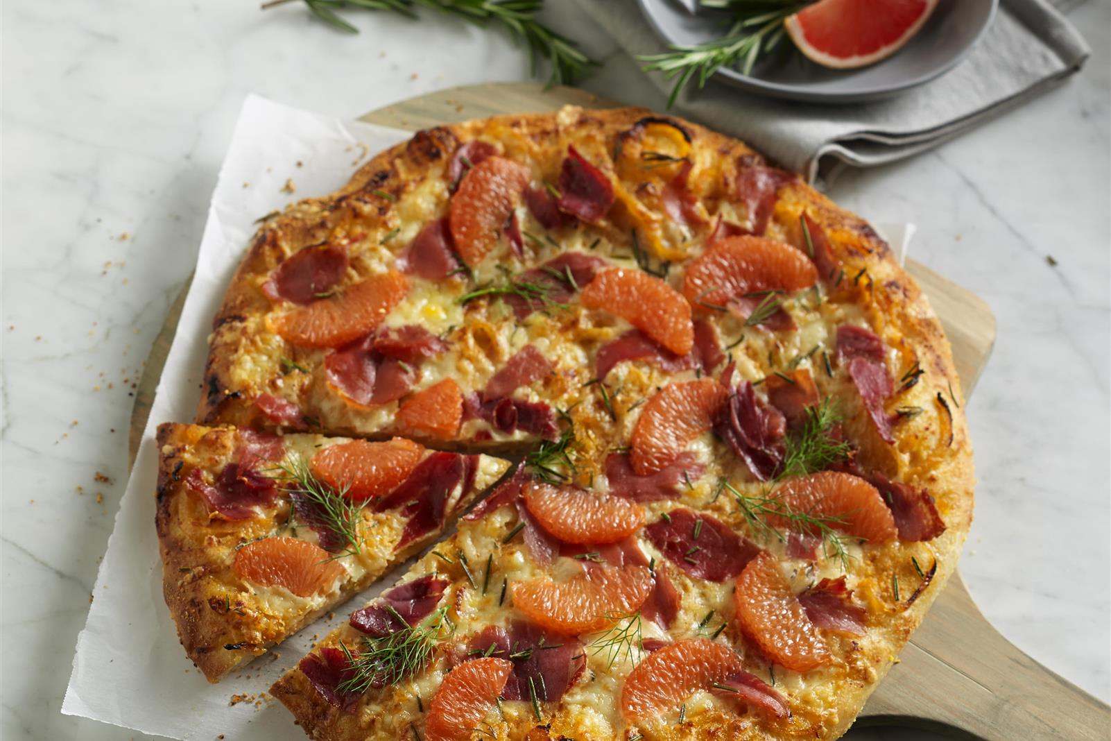 Rosemary Prosciutto Pizza with Spicy Grapefruit Caramelized Fennel and Onio